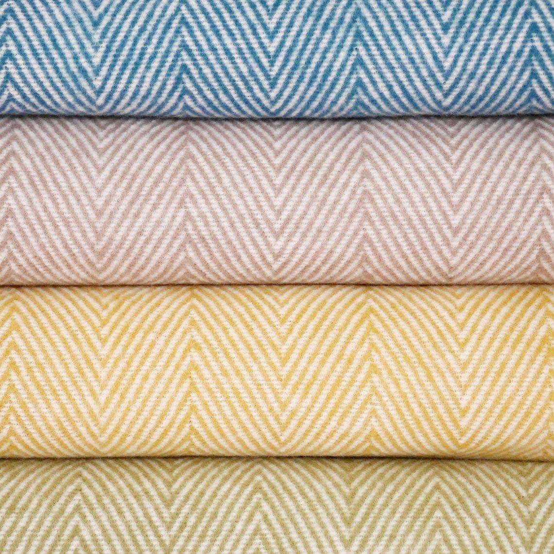 Vier verschiedenfarbige Baumwolldecken übereinandergelegt